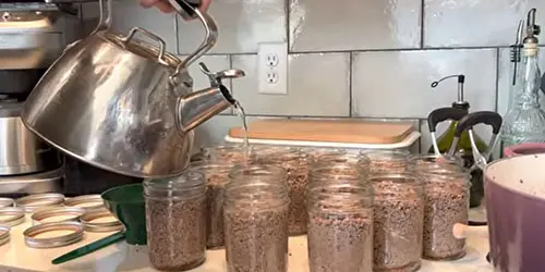 Adding boiled water to meat in jars!