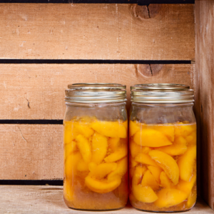 canned peaches in two glass jars