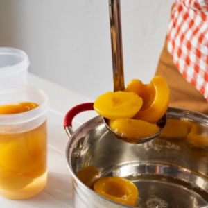 woman canning peaches