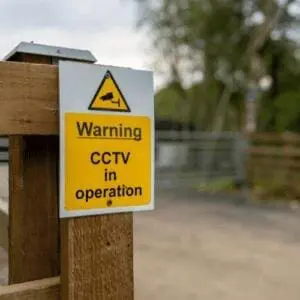 home surveillance warning sign on property entrance