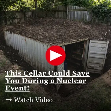 An underground cellar built into a dirt-covered shipping container with a red play button overlay and text that reads, This Cellar Could Save You During a Nuclear Event! Watch Video.