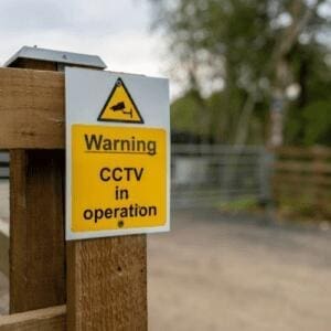 home surveillance warning sign on property entrance