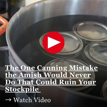 The One Canning Mistake the Amish Would Never Do That Could Ruin Your Stockpile Glass mason jars with metal lids submerged in boiling water inside a large stainless steel pot during a water bath canning process
