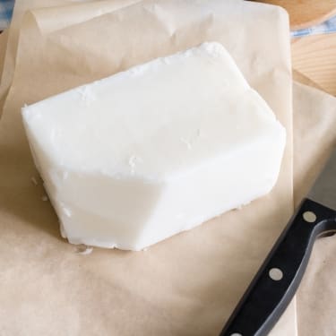 a block of lard on a paper sheet 