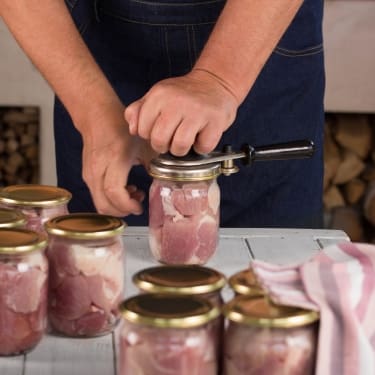 person canning meat at home